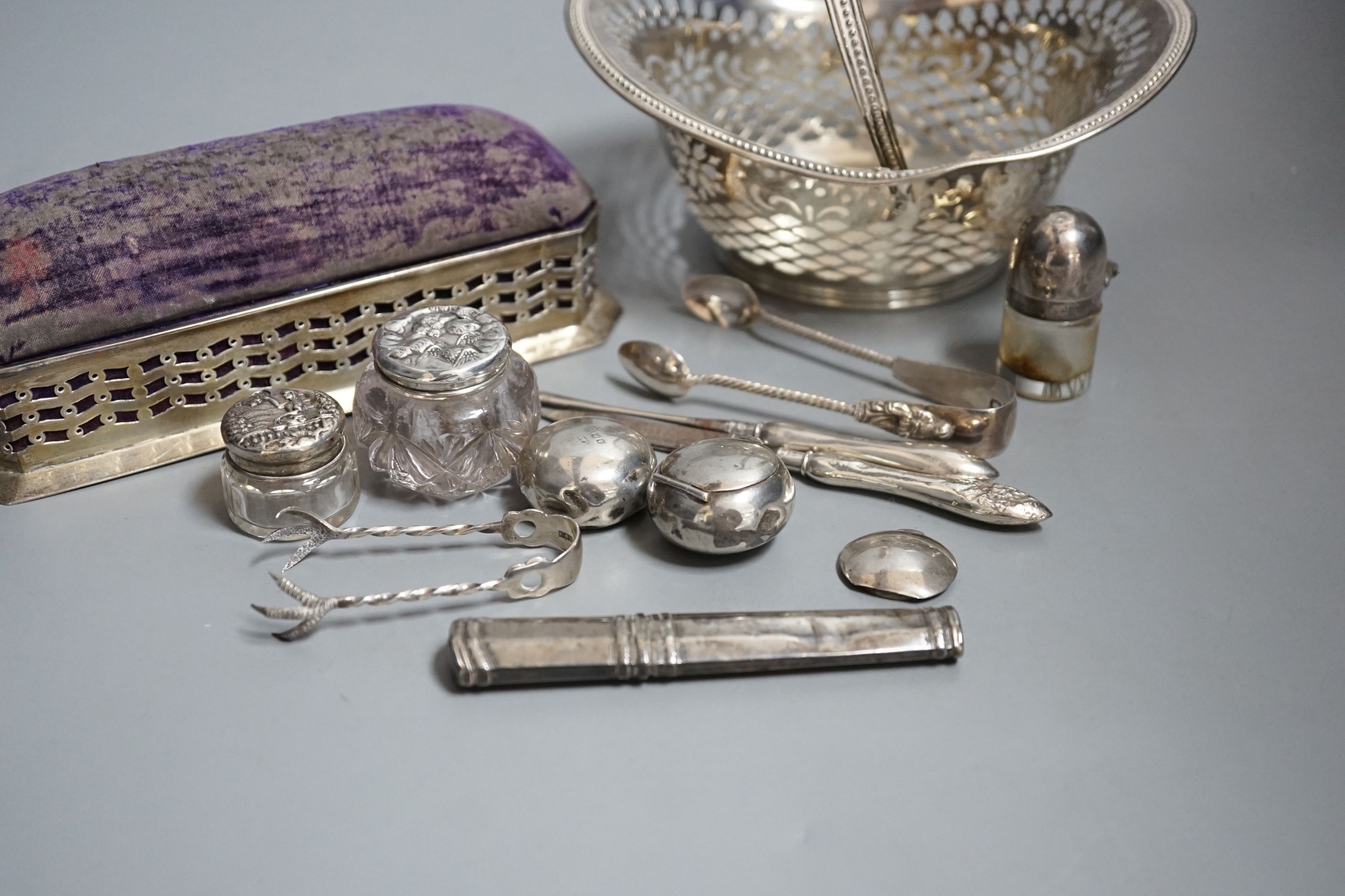 Small silver including two pill boxes, a silver mounted pin cushion, a sterling bonbon basket, etc.